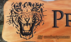 tiger face carved into macrocarpa wood