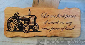 macrocarpa slab carved with the image of a cow, link to farm gate plaques